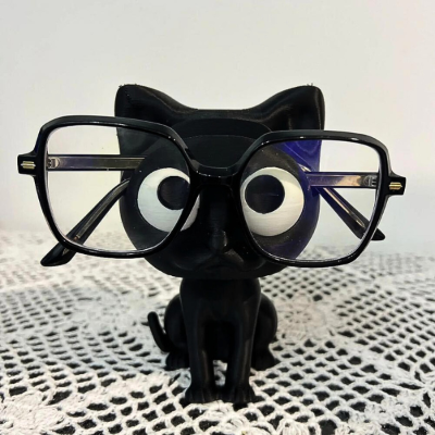 porte lunettes figurine chat noir sur table nappe crochet