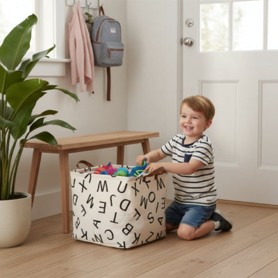 garçon souriant range chaussures dans panier rangement coton alphabet