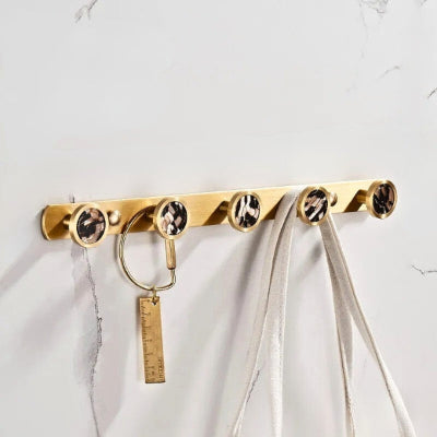 porte manteau doré boutons mosaïque noir