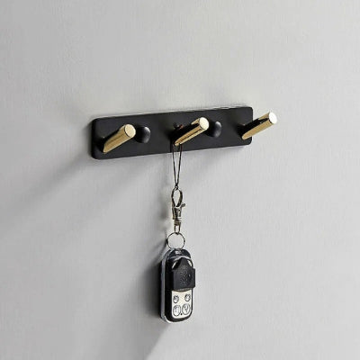 porte manteau mural doré noir trois crochets obliques