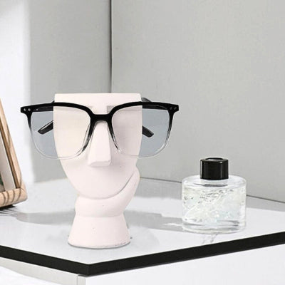 support lunette visage minimaliste blanc bouteille parfum cadre