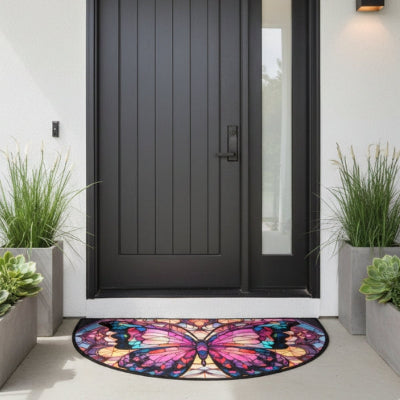 tapis entrée papillon coloré devant porte grise bacs plantes vertes